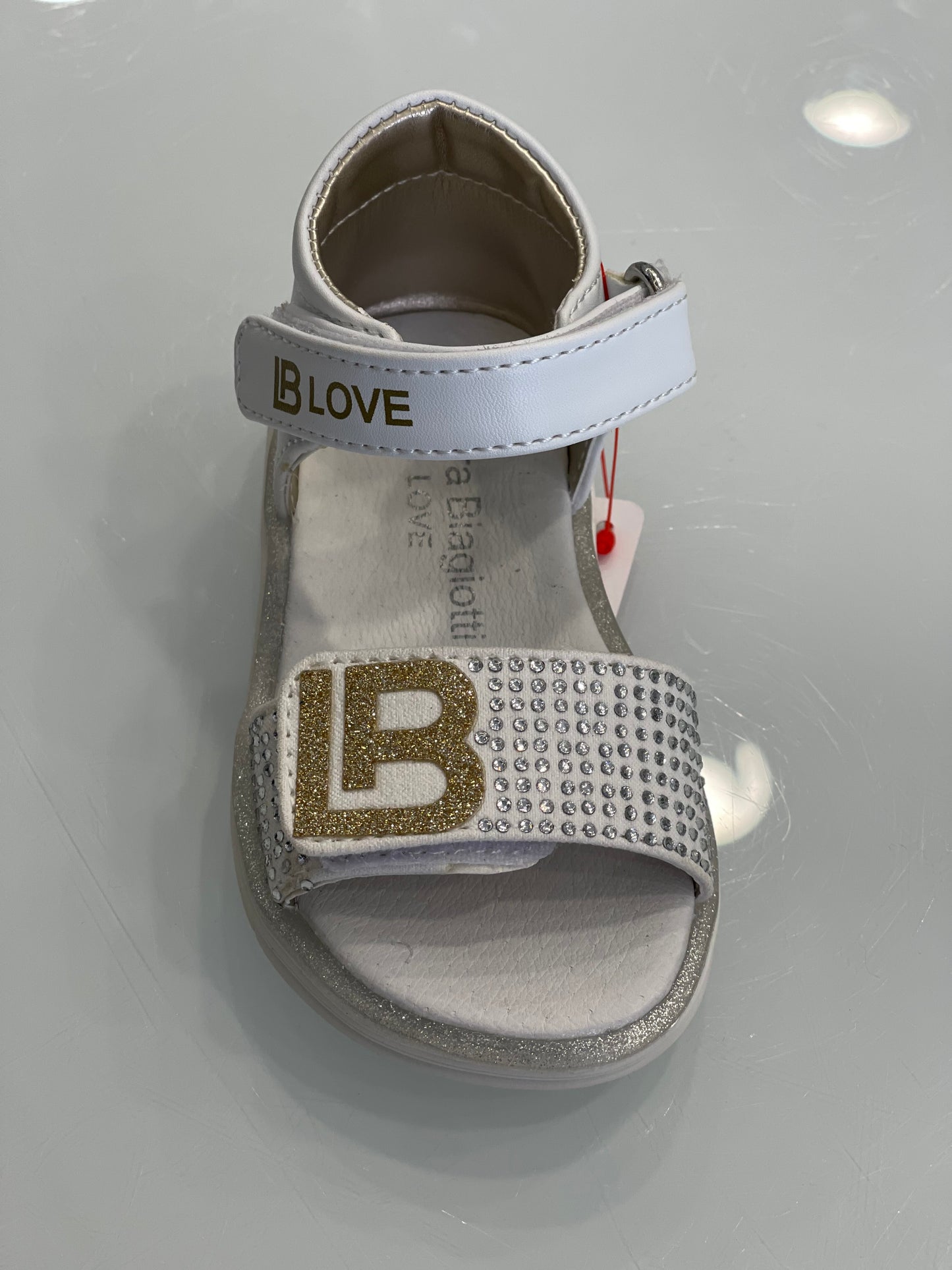 LAURA BIAGIOTTI - Sandalo bianco con logo oro e strass