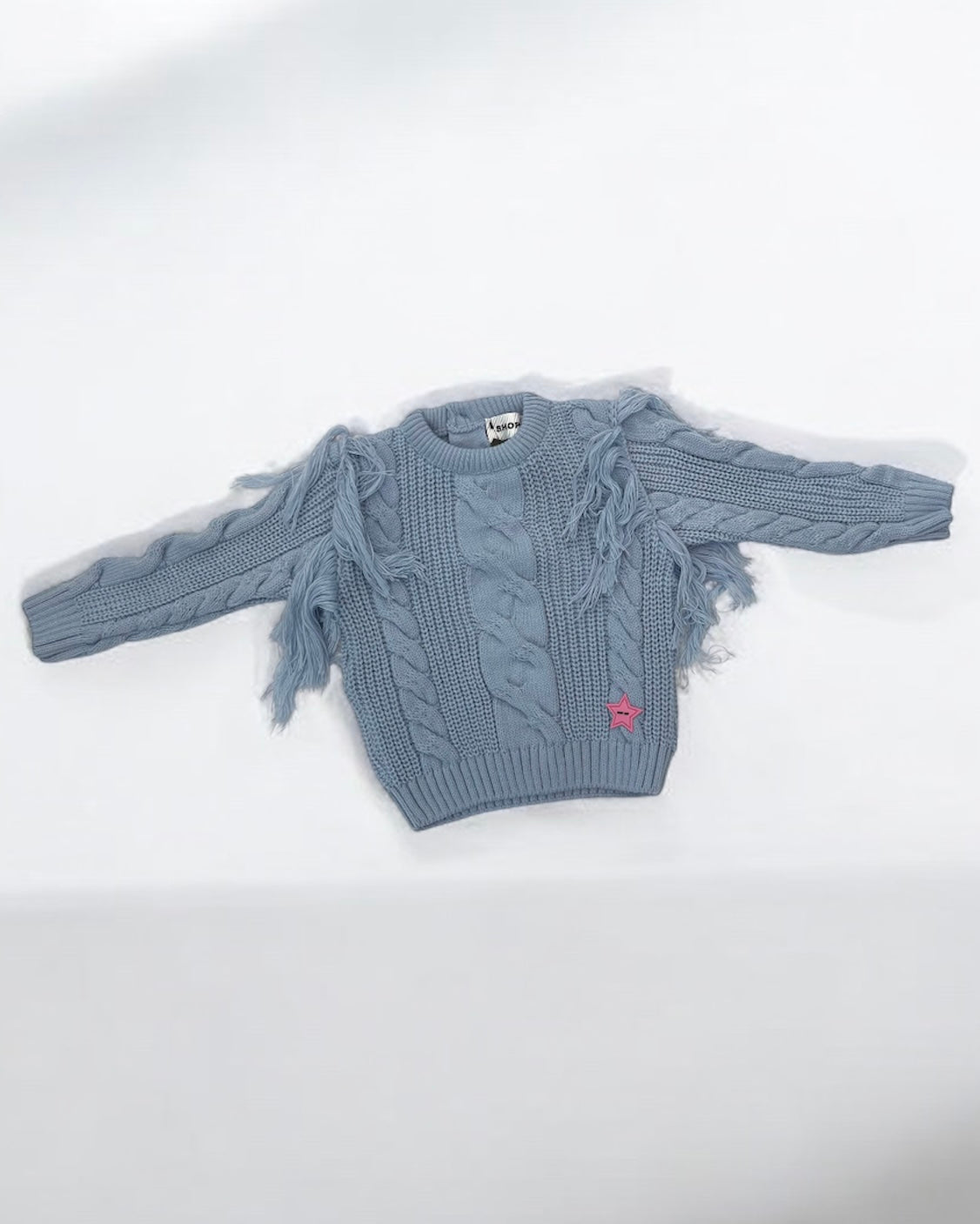 SHOP ART - Maglioncino celeste polvere con frange in lana intrecciata bambina