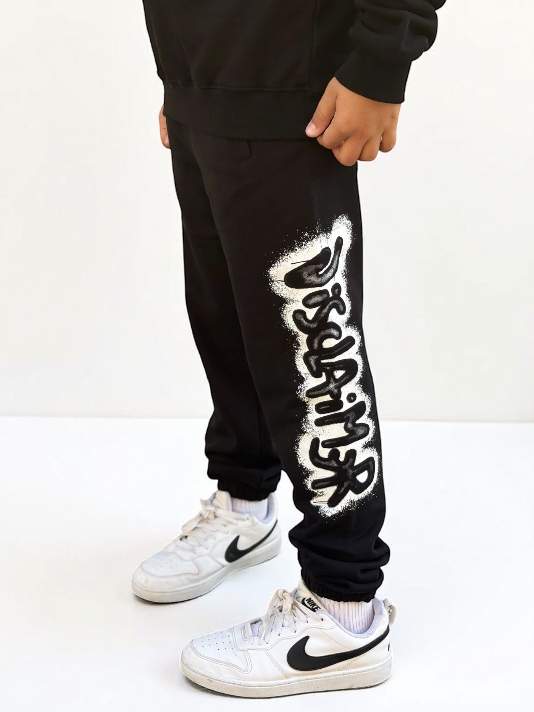 DISCLAIMER - Pantalone logo spray bambino